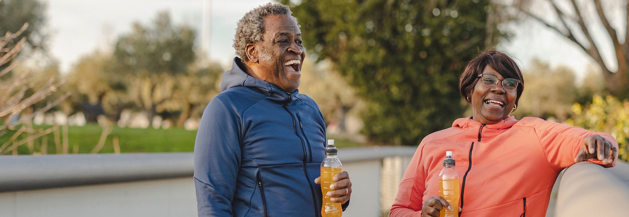 Active middle-aged man and woman outside.