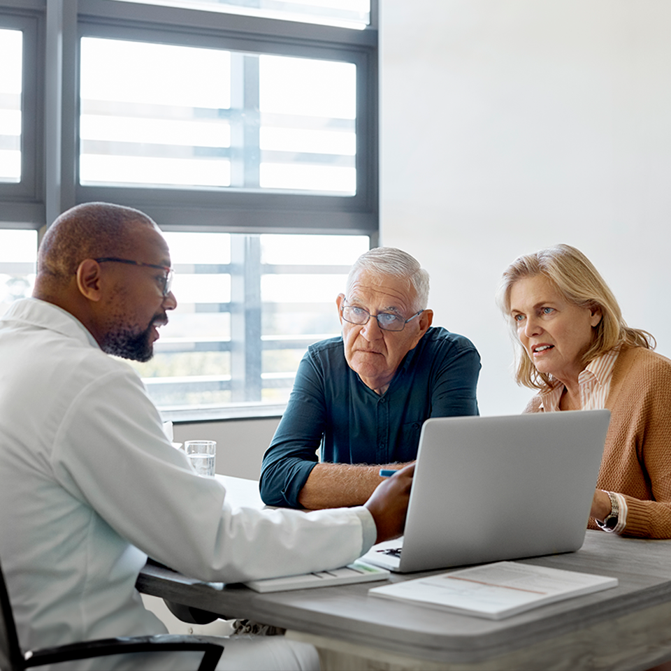couple conversing with doctor
