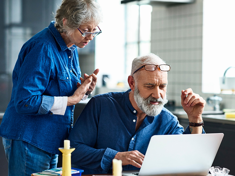 Man and woman looking at a laptop.