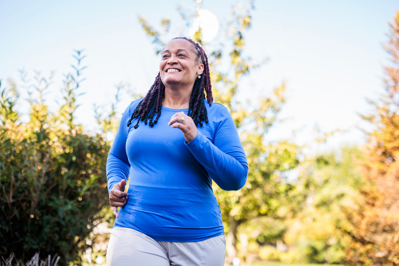 older woman jogging outside.