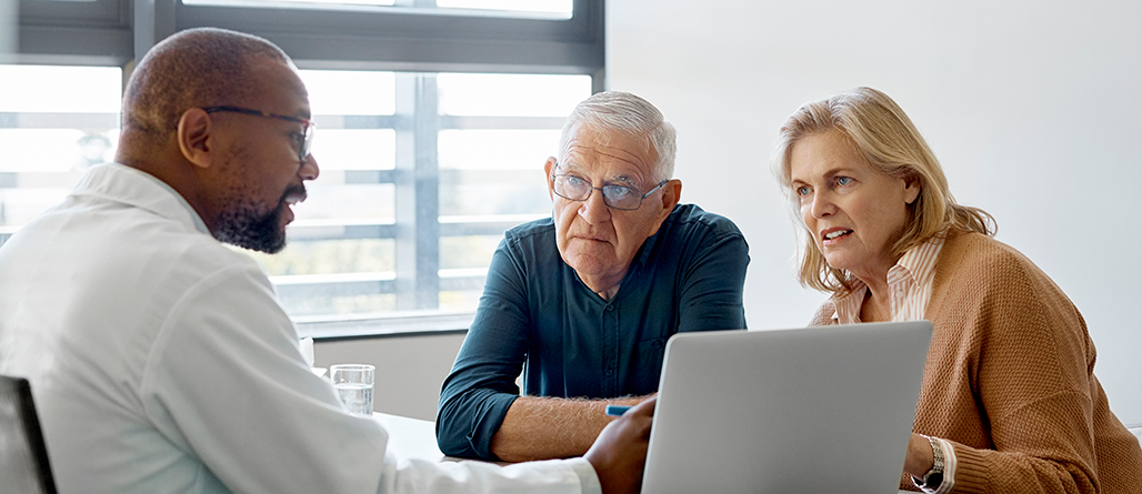 couple conversing with doctor